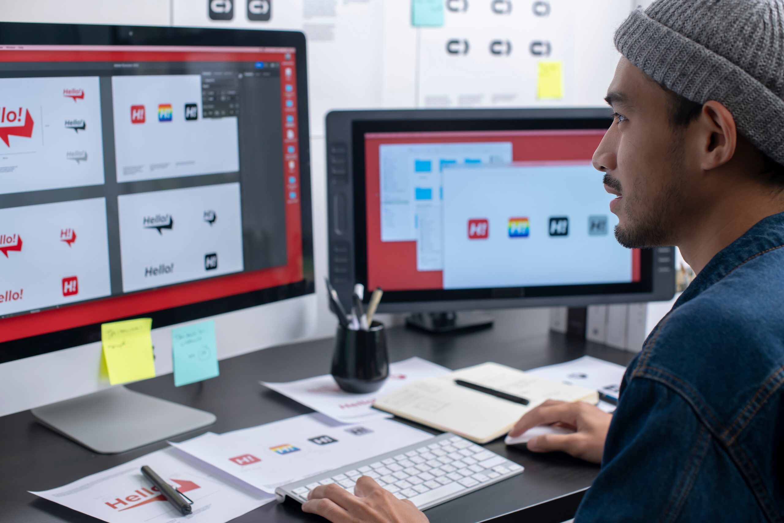 creative workspace with branding materials and digital ad designs