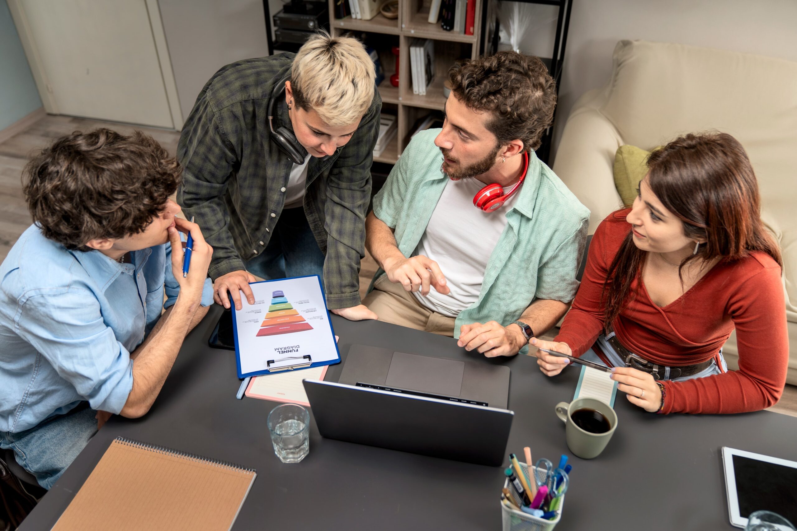 Creative team mapping full-funnel strategy on whiteboard with stages labeled