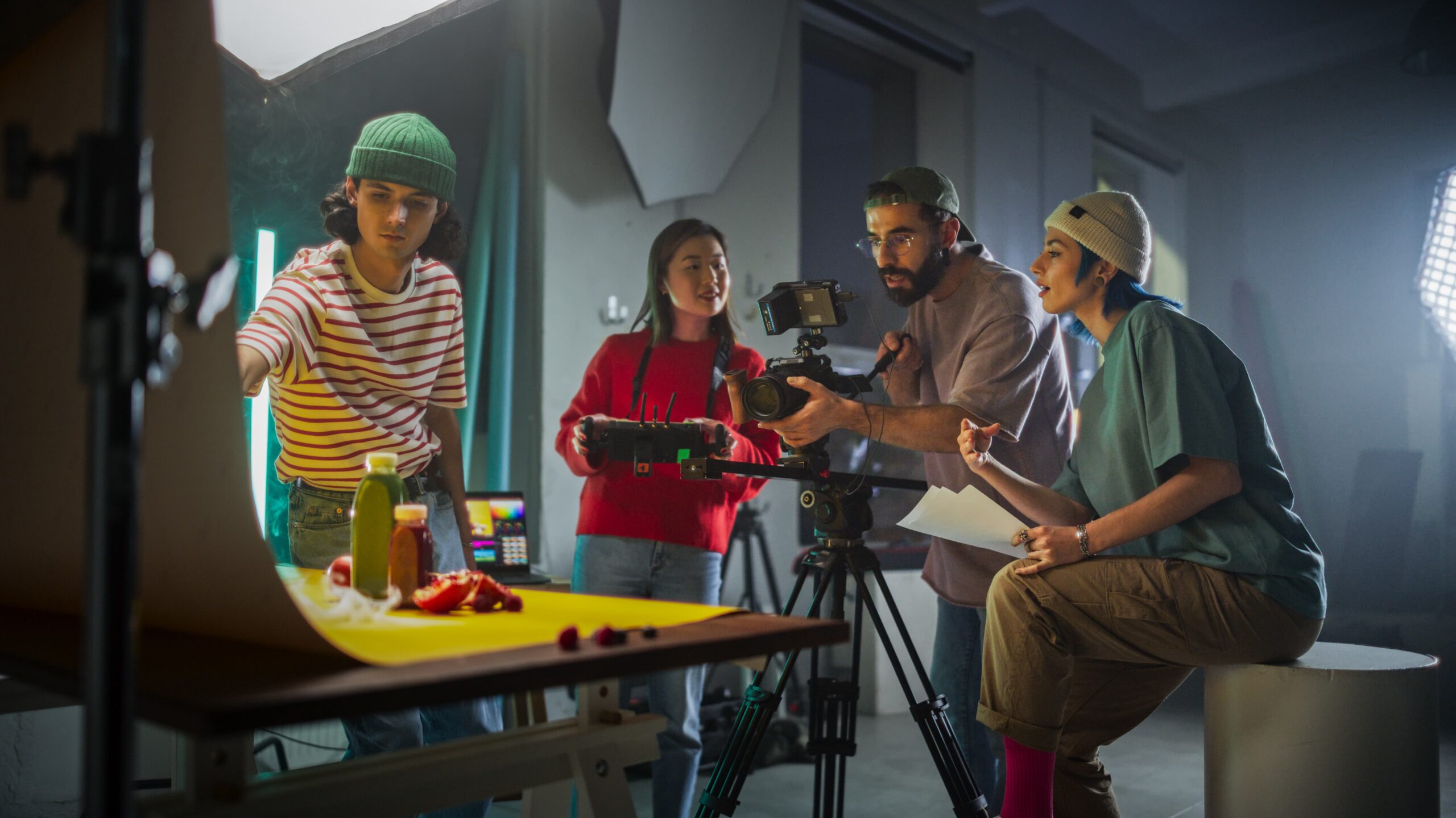 Close-up of young cameraman shooting with professional camera while making content in studio