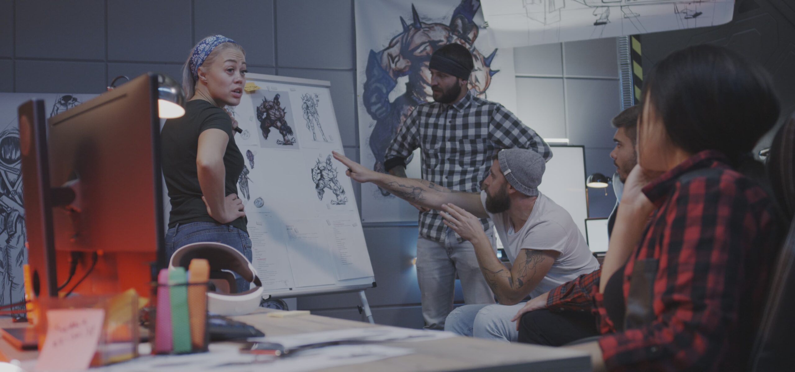 film director and crew reviewing video script on set during pre-production