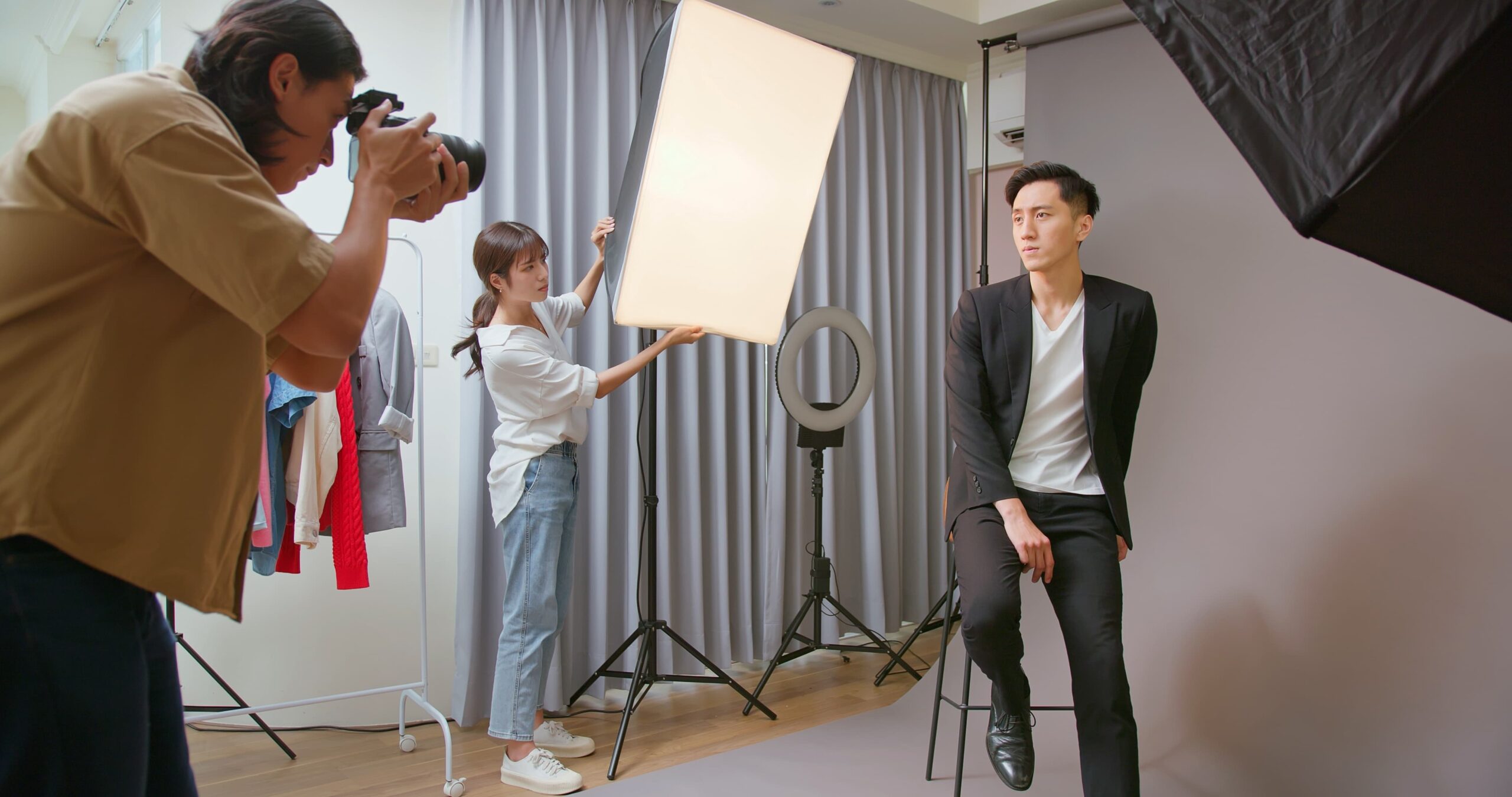 commercial actor being filmed with crew and lighting behind camera