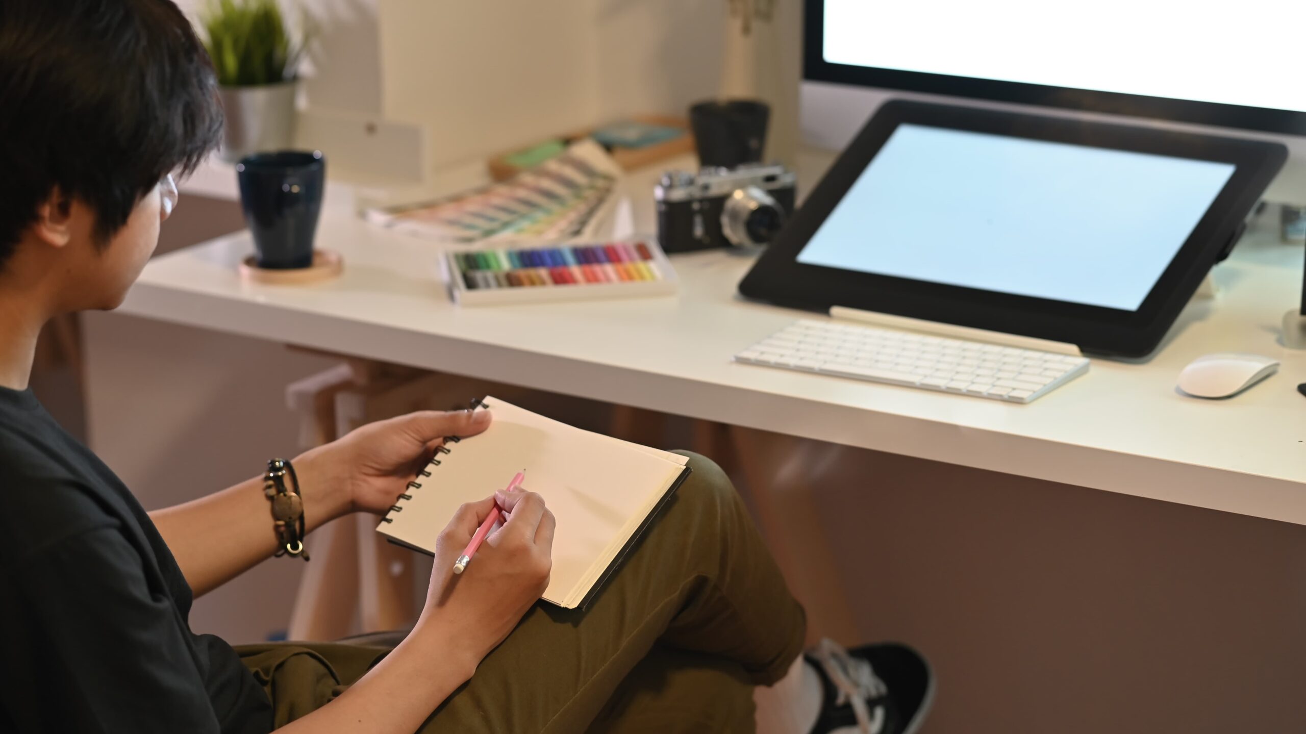 creative director designing brand visuals with sketches and mood boards