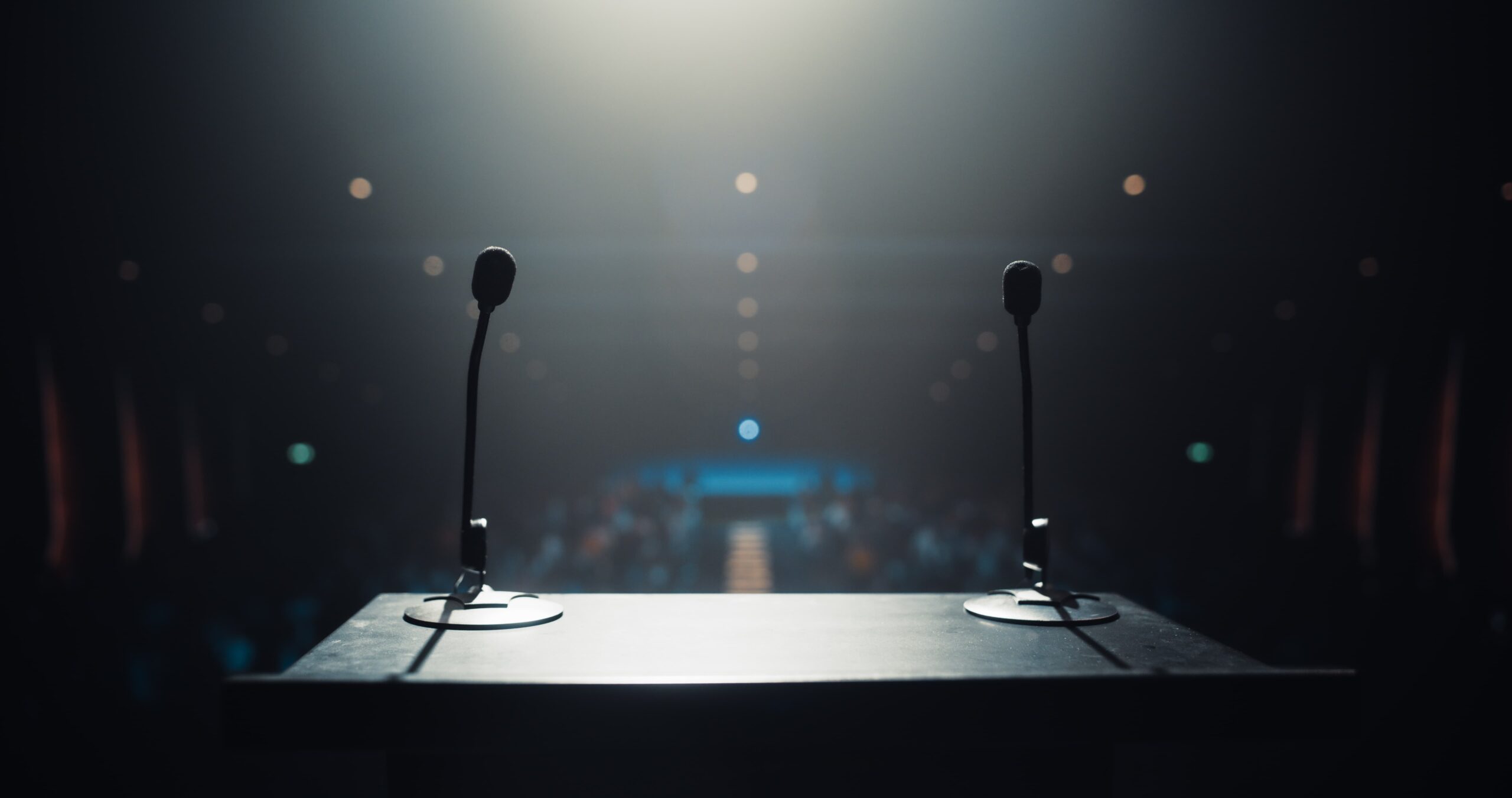 Brand silence illustrated by an unused microphone under a spotlight