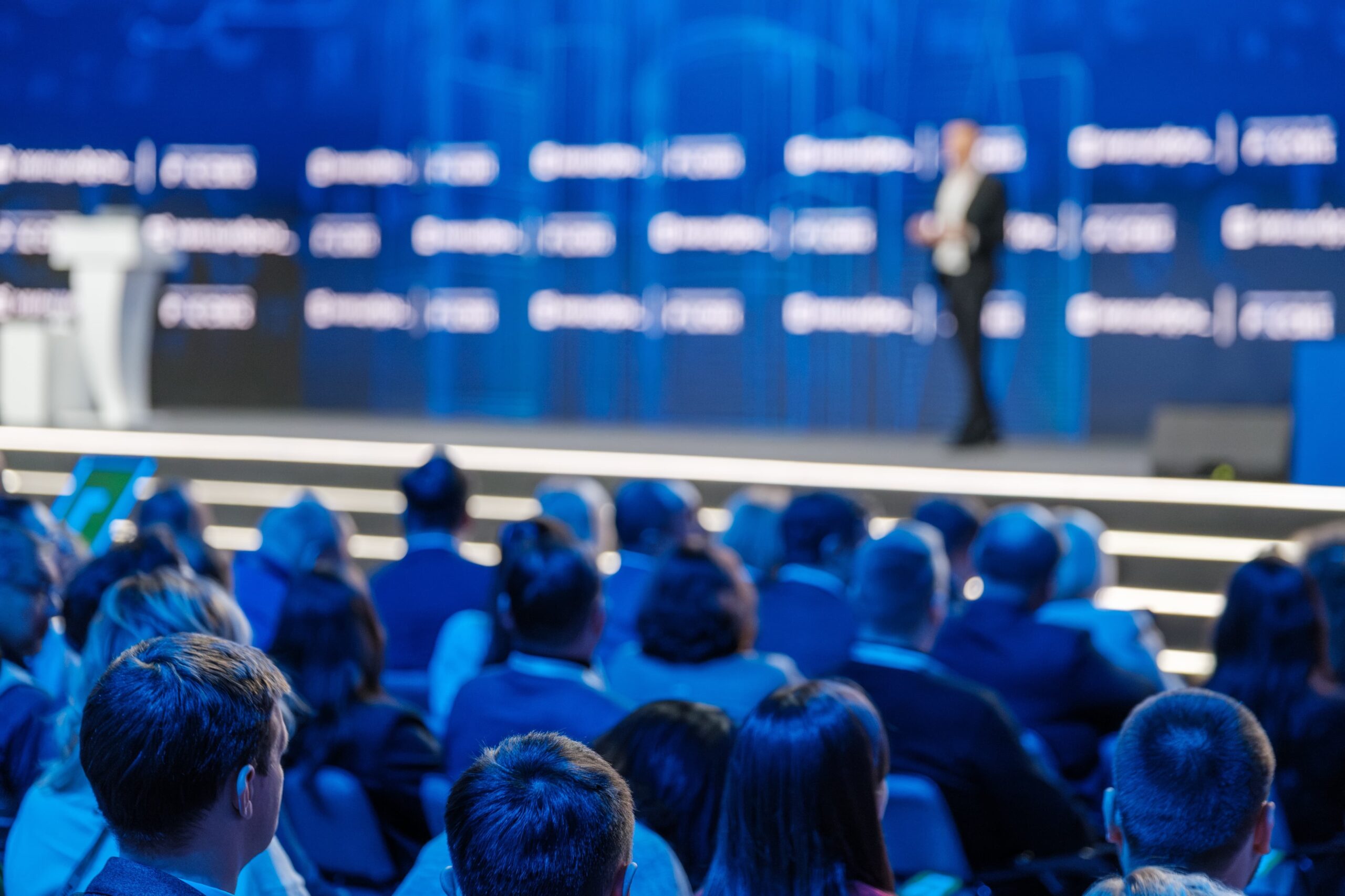 Large corporate event in Los Angeles with stage, lights, and audience