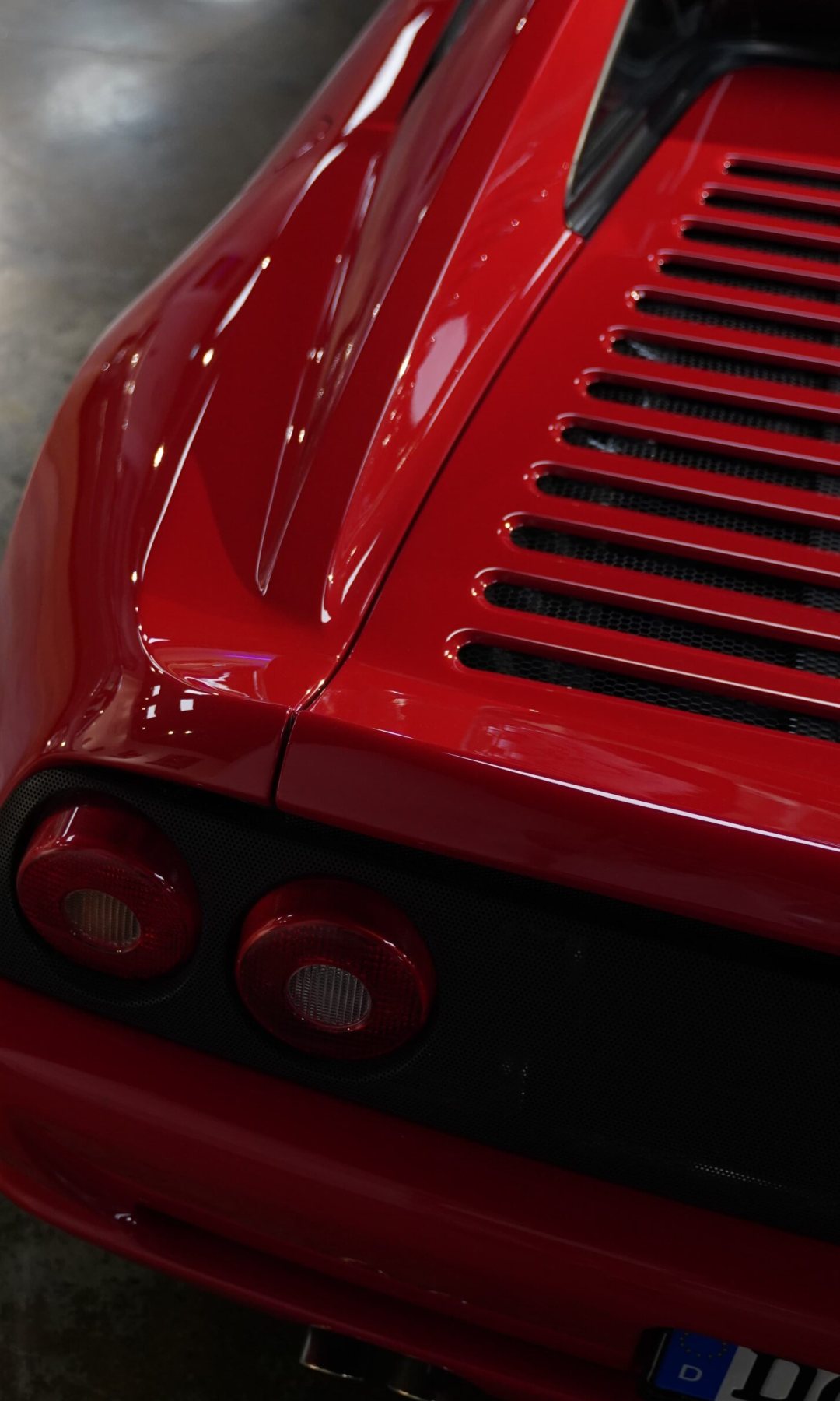 Ferrari F355 from behind: the engine-cover louvres and the round tail lamps