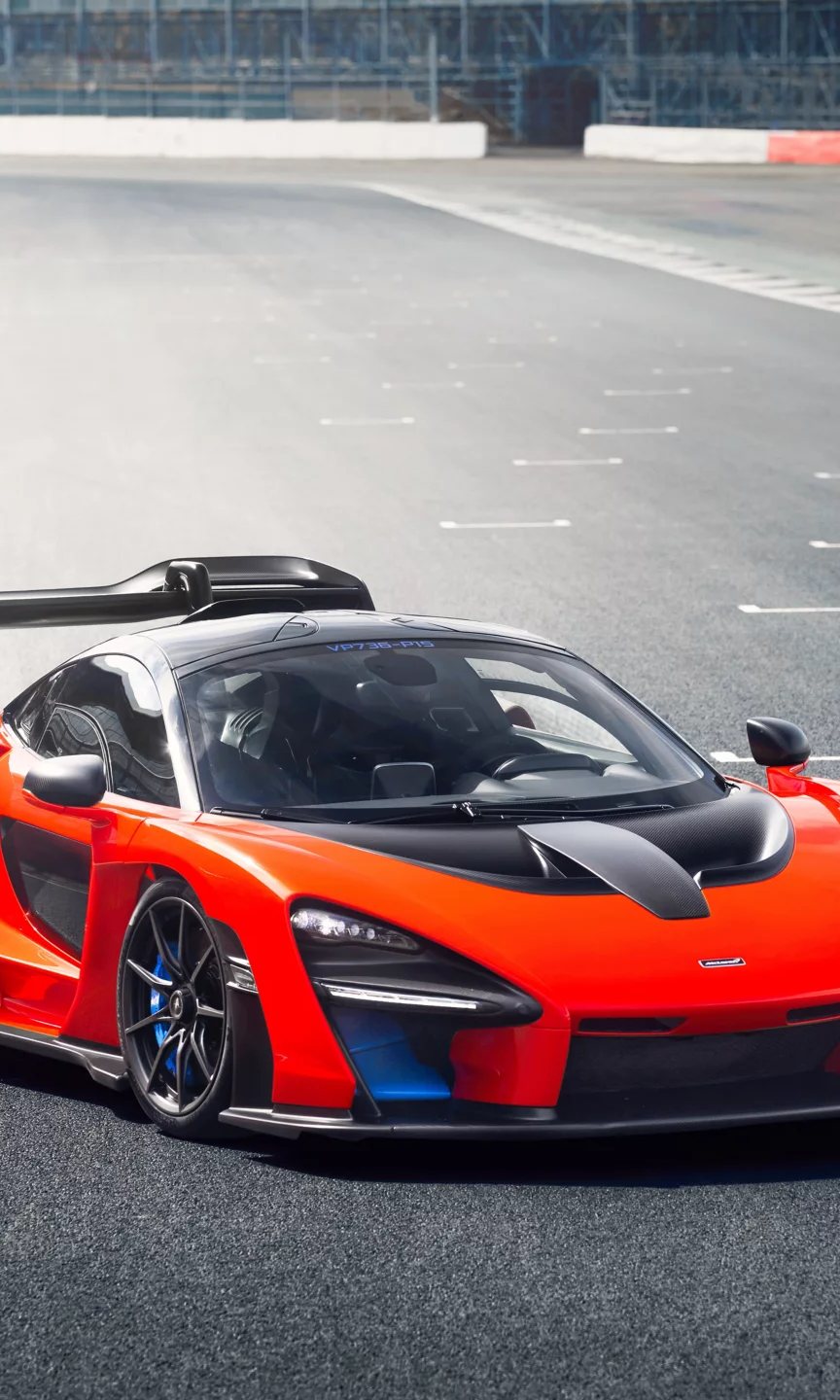 Orange and black McLaren Senna on a race circuit