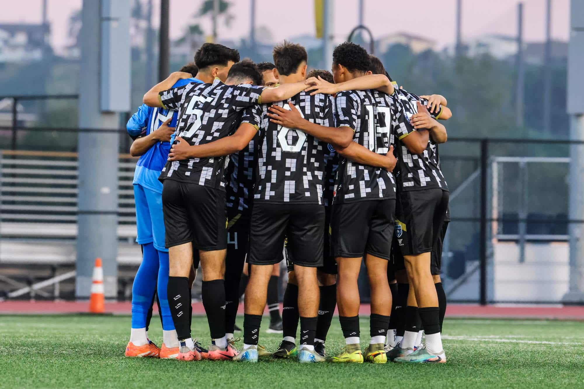 LA Sol Athletics players in a huddle before kick-off, photographed by the club